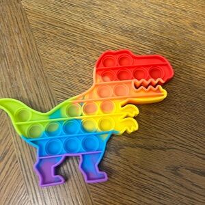 POP-IT DINOSAUR, RAINBOW COLORED SILICON FIDGET TOY. STOCKING STUFFER!